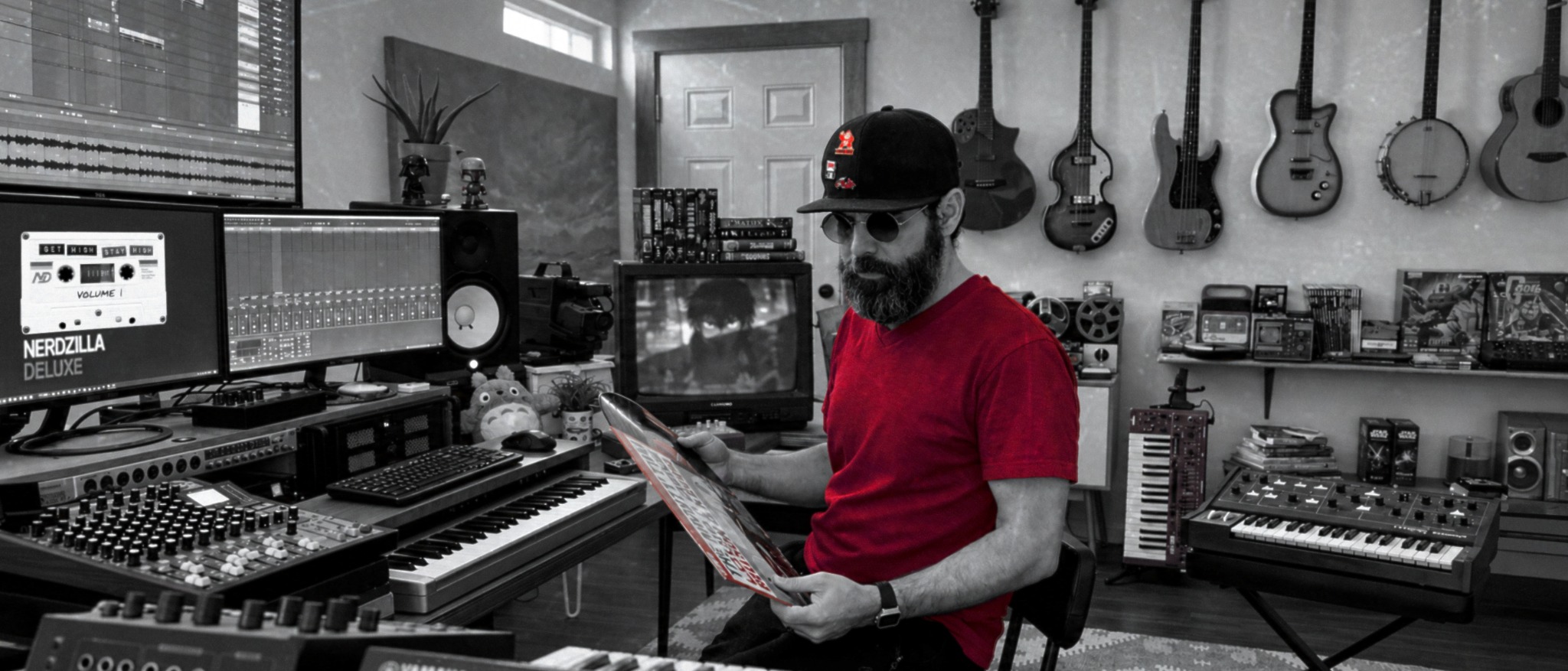 Taylor Jordan in a home music studio surrounded by instruments and recording gear